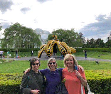 A group of people posing for a picture in front of a large dragon statue

Description automatically generated with low confidence